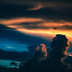 Plane in Cloudy Sunset