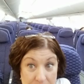 Sharon Leonard waiting on a nearly empty airplane