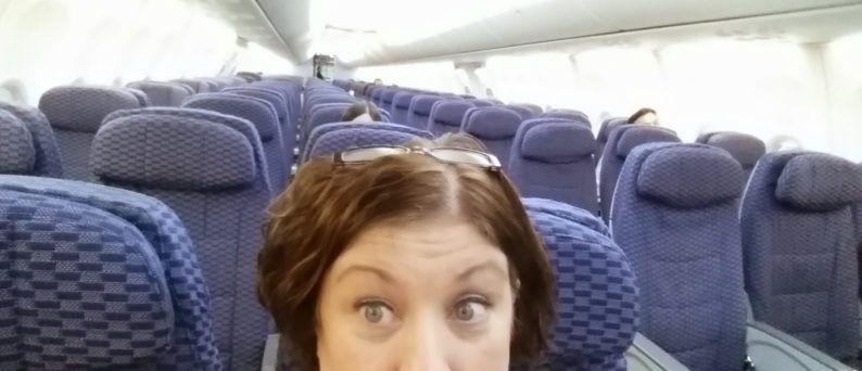 Sharon Leonard waiting on a nearly empty airplane