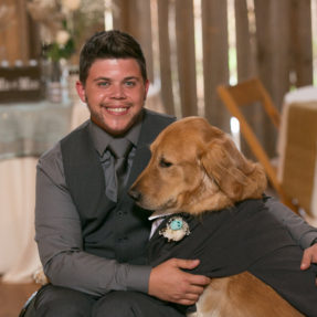 Kade Patterson Posing at a Formal Event with a Dog